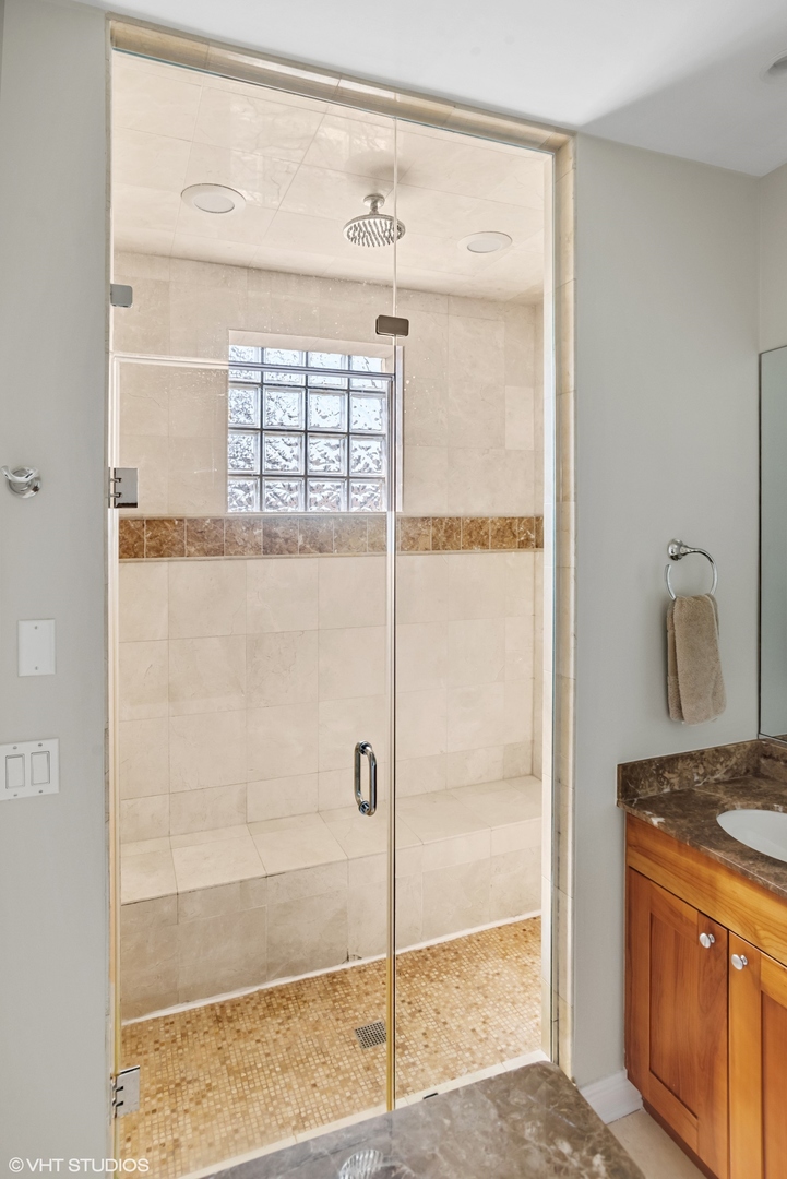 1411 West Chicago Avenue, Unit 3 Chicago, IL 60642 - Photo 12 of 19 a bathroom with a granite countertop sink and shower