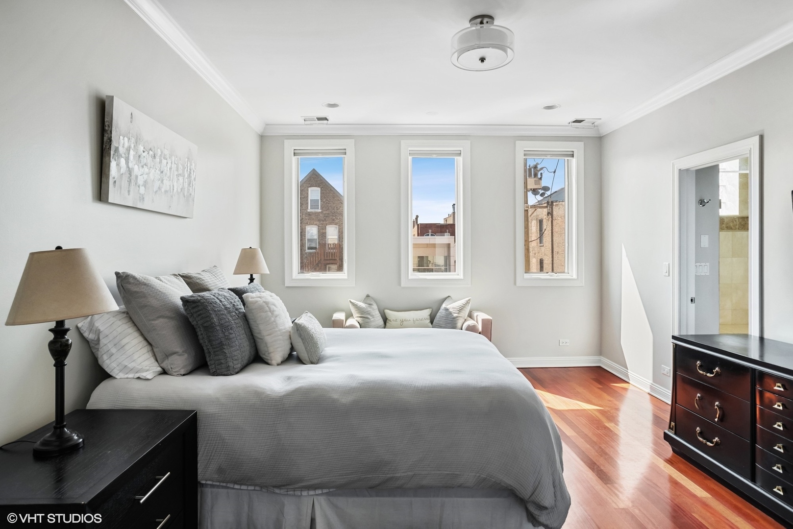 1411 West Chicago Avenue, Unit 3 Chicago, IL 60642 - Photo 9 of 19 a bedroom with a bed and a lamp on the dresser