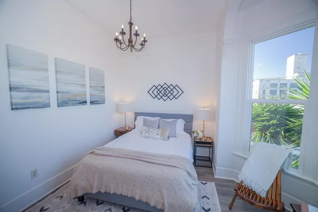 a bed room with a bed and a chair