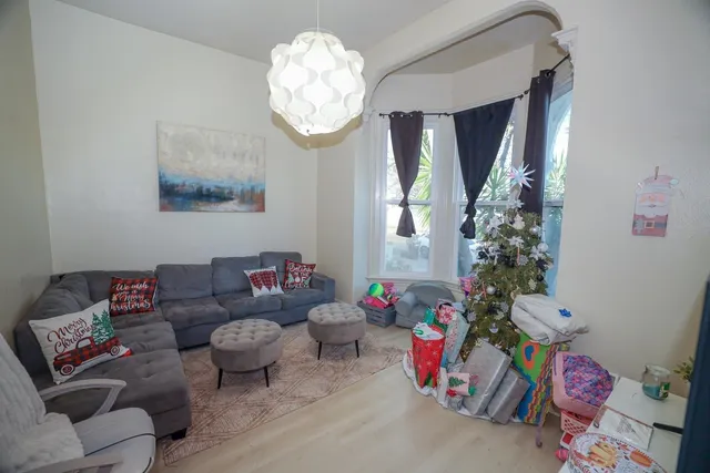 a living room with furniture and a chandelier