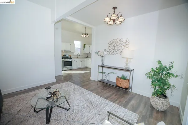 a living room with furniture flowerpot and a chandelier