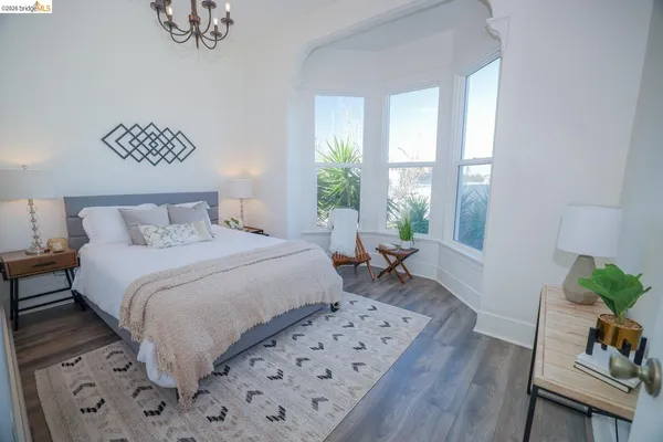 a bedroom with bed and wooden floor