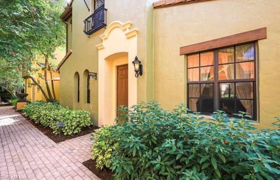 9128 Delano Street, Unit 892 Naples, FL 34113 - Photo 34 of 49 a front view of a house with a garden