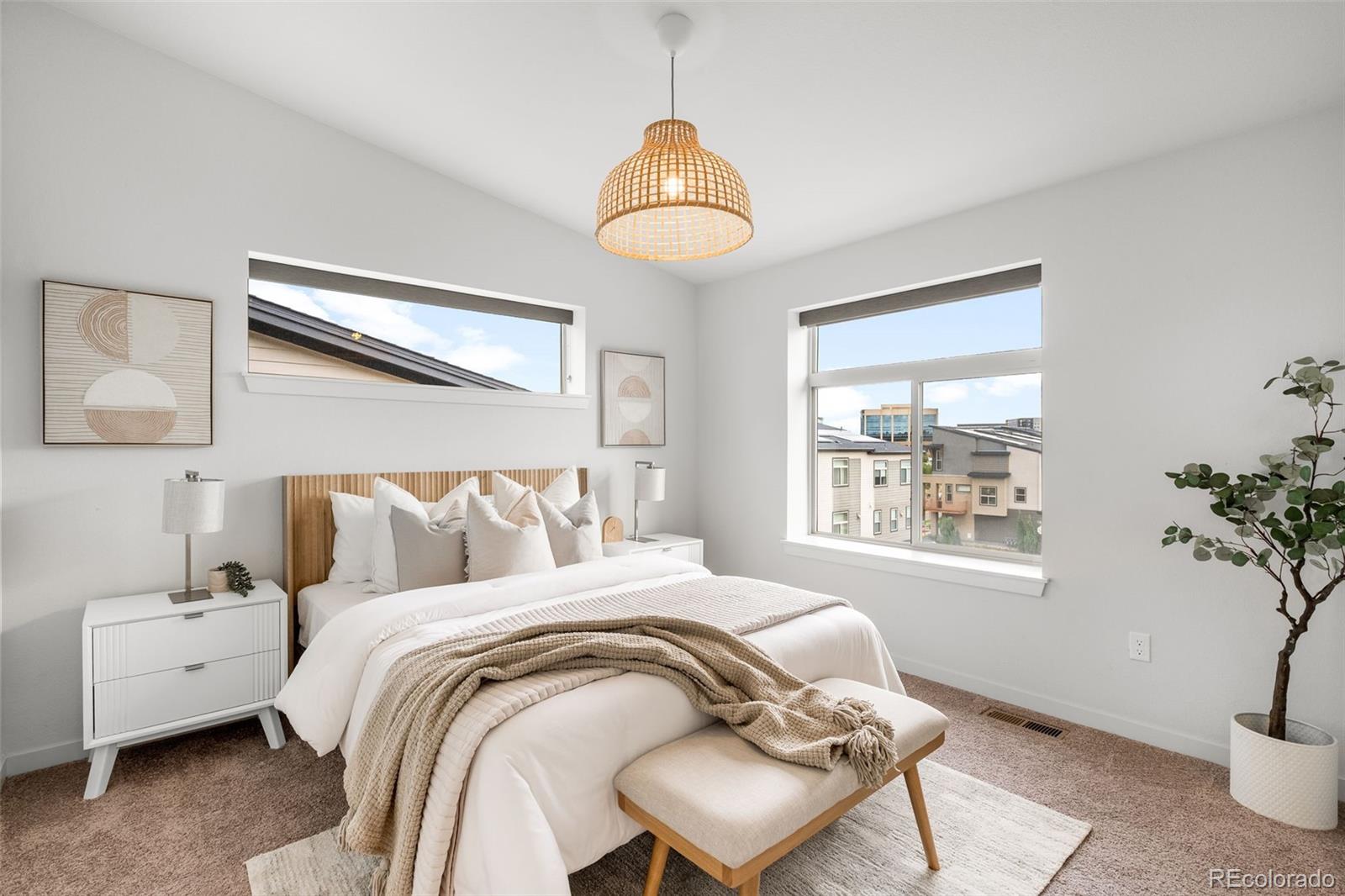 10053 Town Ridge Lane Lone Tree, CO 80124 - Photo 14 of 17 a bedroom with a bed and a chandelier