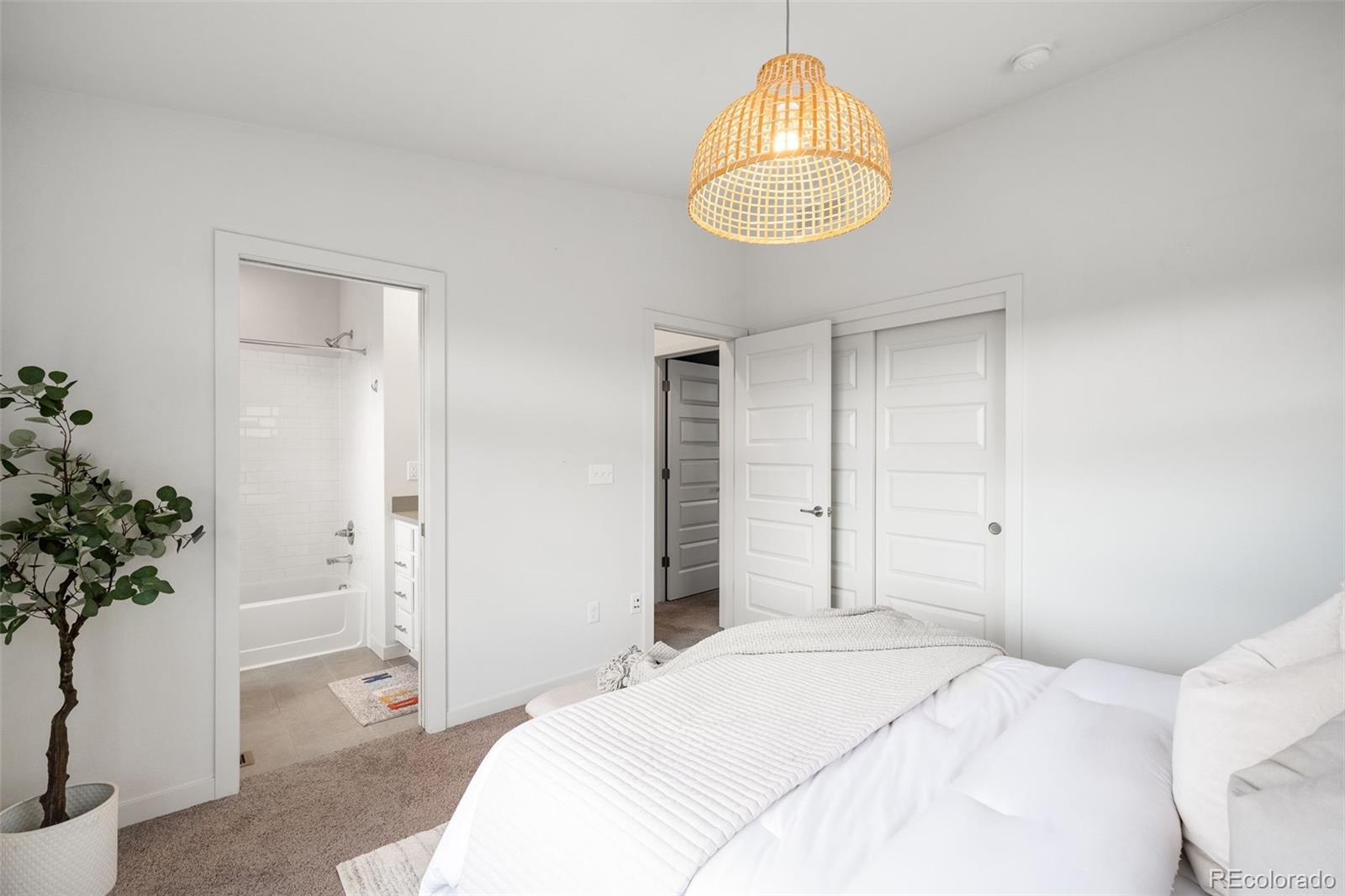 10053 Town Ridge Lane Lone Tree, CO 80124 - Photo 15 of 17 a bedroom with a bed and a potted plant