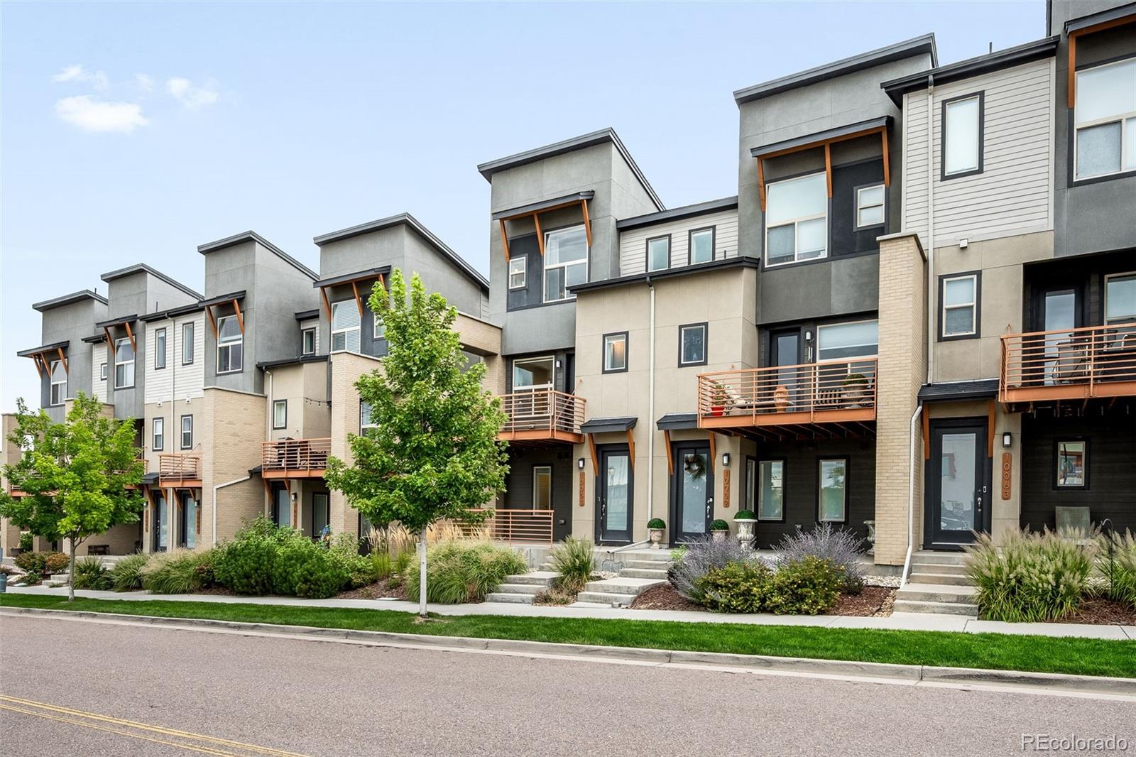 10053 Town Ridge Lane Lone Tree, CO 80124 - Photo 2 of 17 a front view of a residential apartment building with a yard