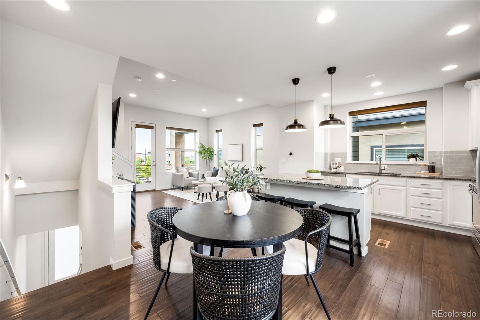 10053 Town Ridge Lane Lone Tree, CO 80124 - Photo 3 of 17 a kitchen with a table and chairs in it