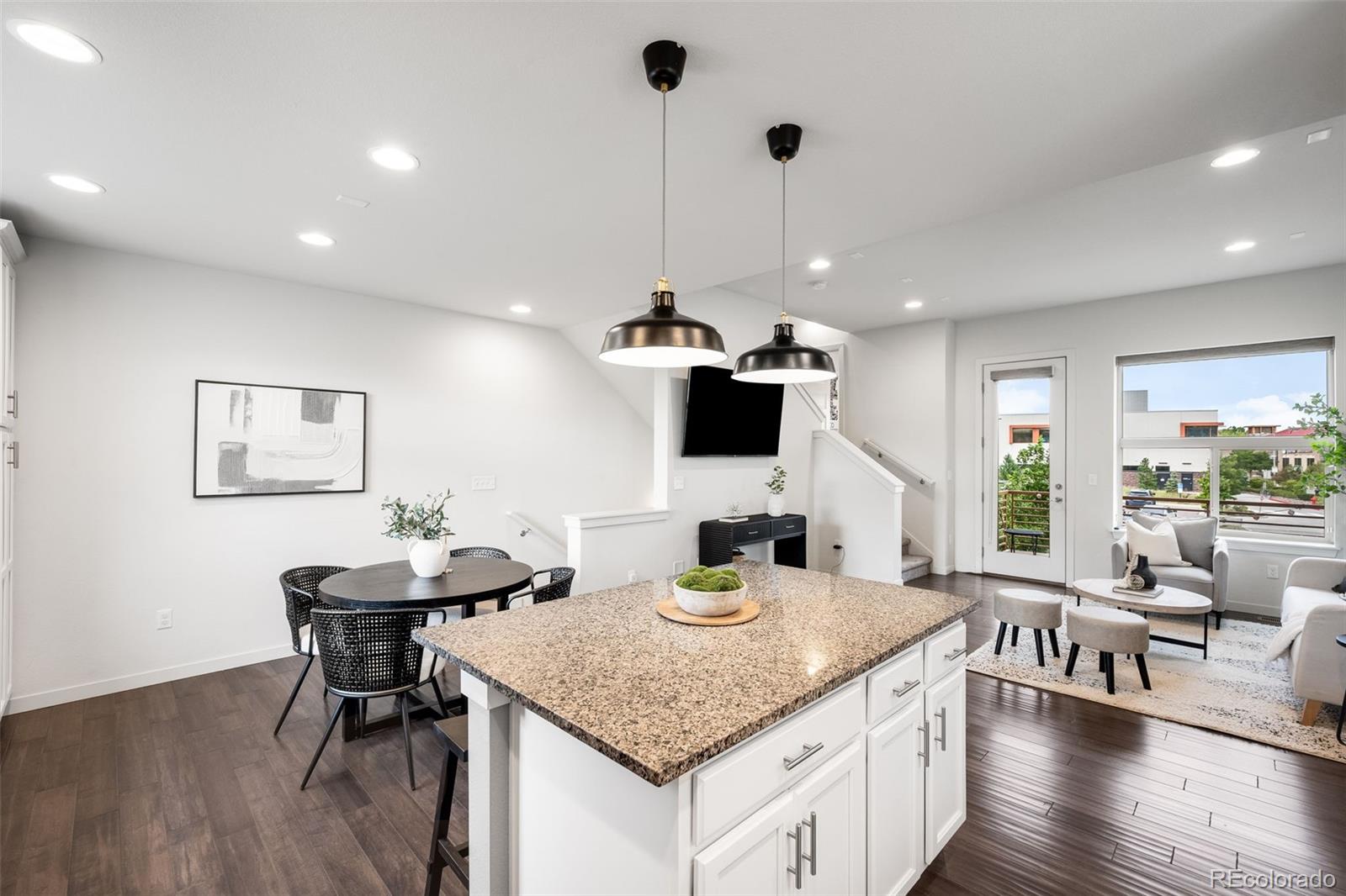 10053 Town Ridge Lane Lone Tree, CO 80124 - Photo 6 of 17 a kitchen with stainless steel appliances granite countertop sink stove and wooden floor