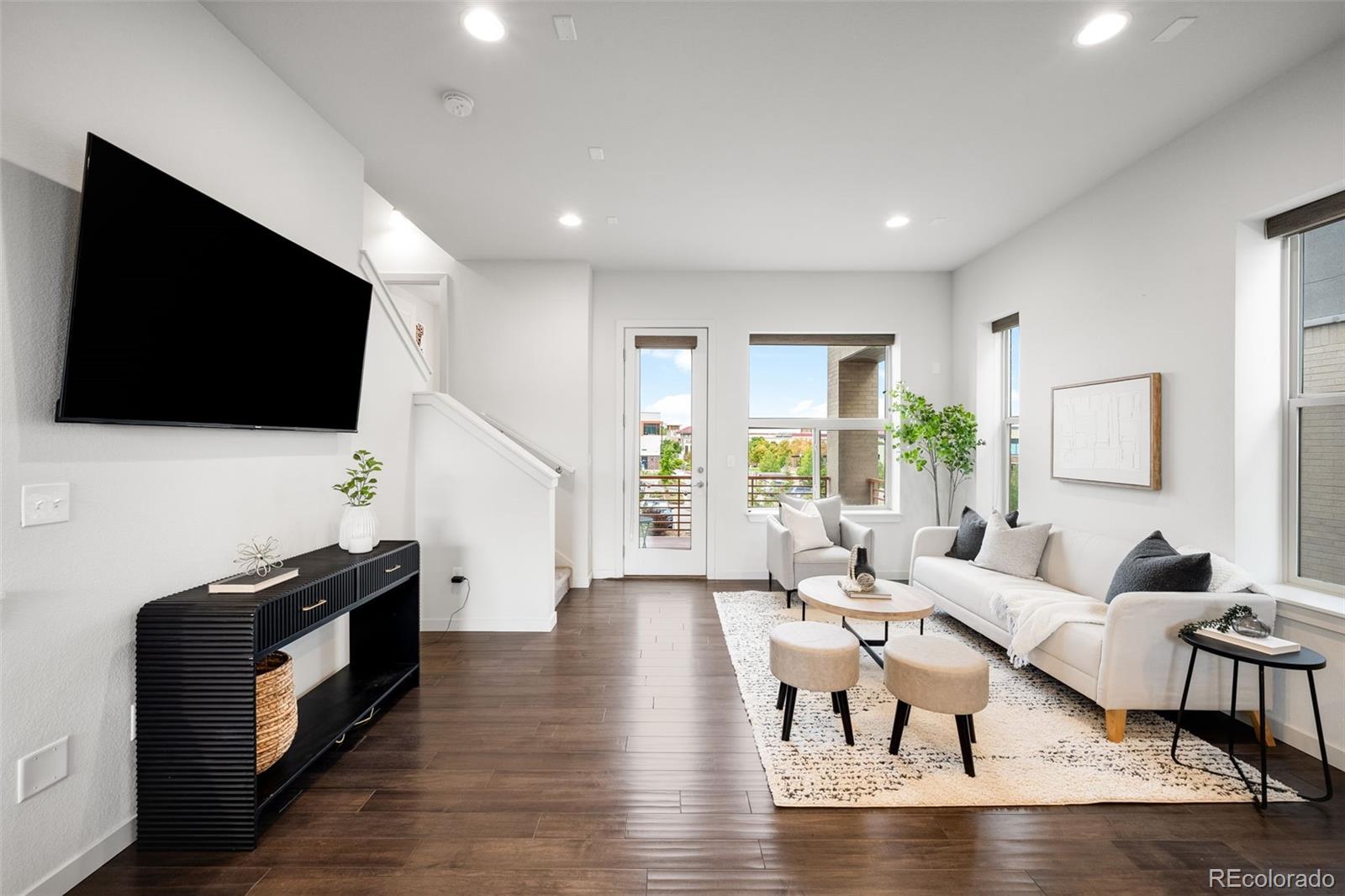 10053 Town Ridge Lane Lone Tree, CO 80124 - Photo 7 of 17 a living room with furniture and a flat screen tv