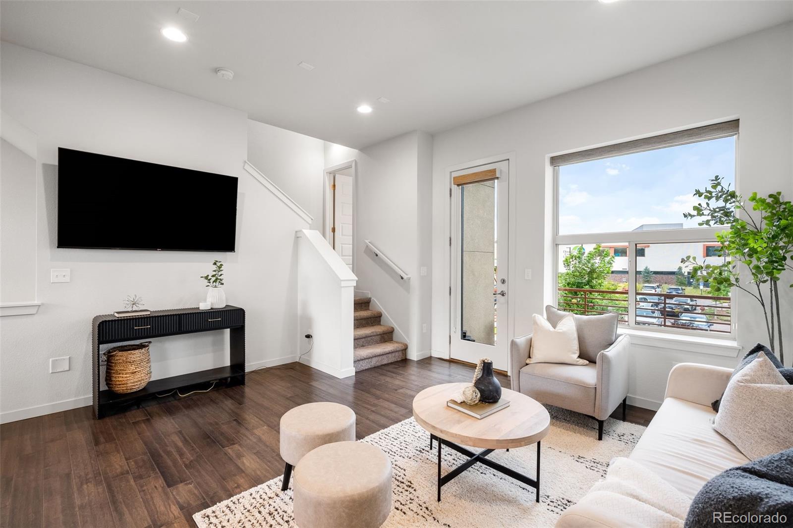 10053 Town Ridge Lane Lone Tree, CO 80124 - Photo 8 of 17 a living room with furniture and a flat screen tv