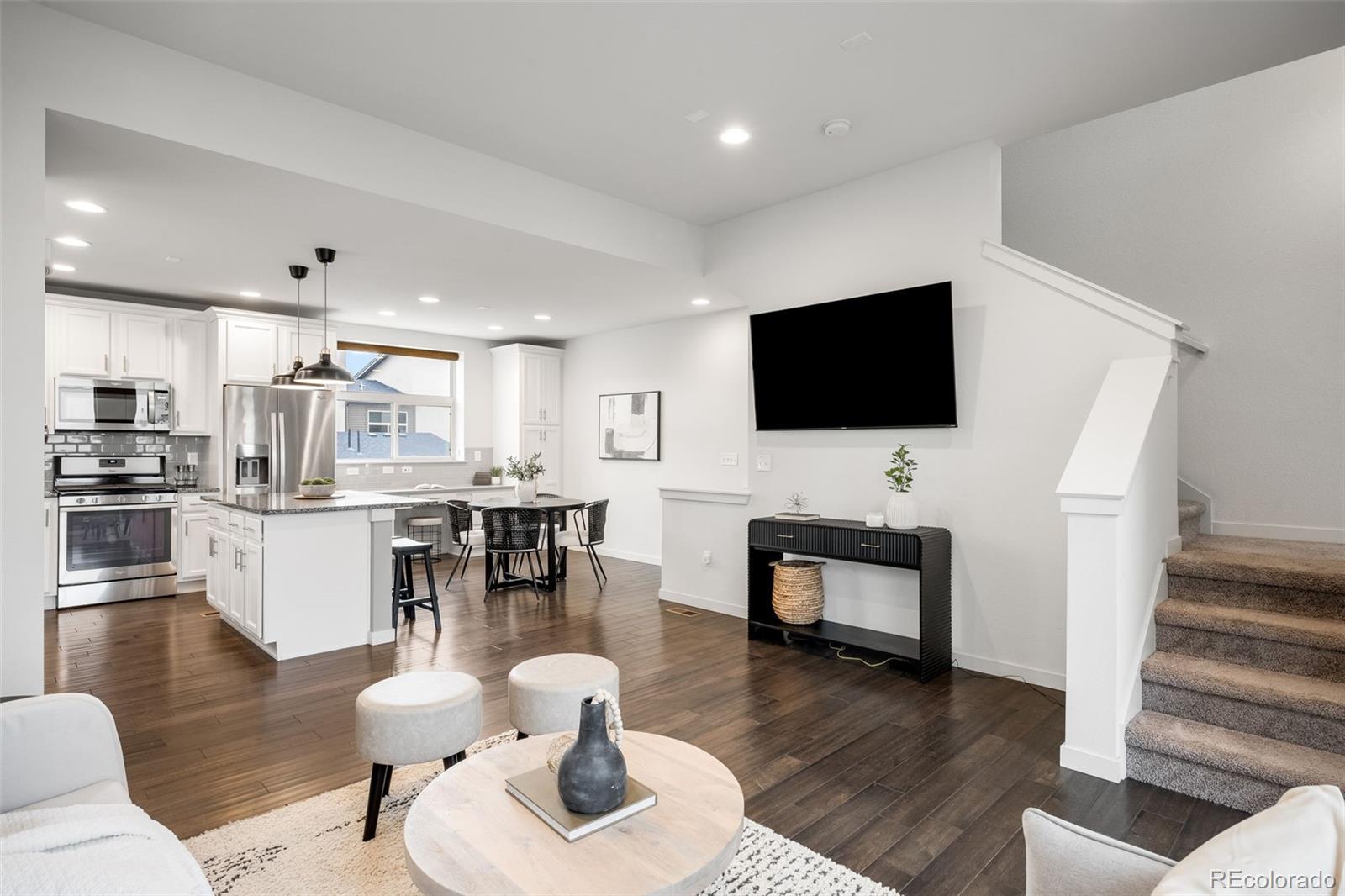 10053 Town Ridge Lane Lone Tree, CO 80124 - Photo 9 of 17 a living room with furniture and a flat screen tv