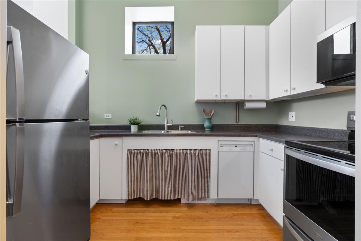 2001 West Ohio Street, Unit 1N Chicago, IL 60612 - Photo 8 of 13 a kitchen with stainless steel appliances granite countertop a refrigerator sink and microwave