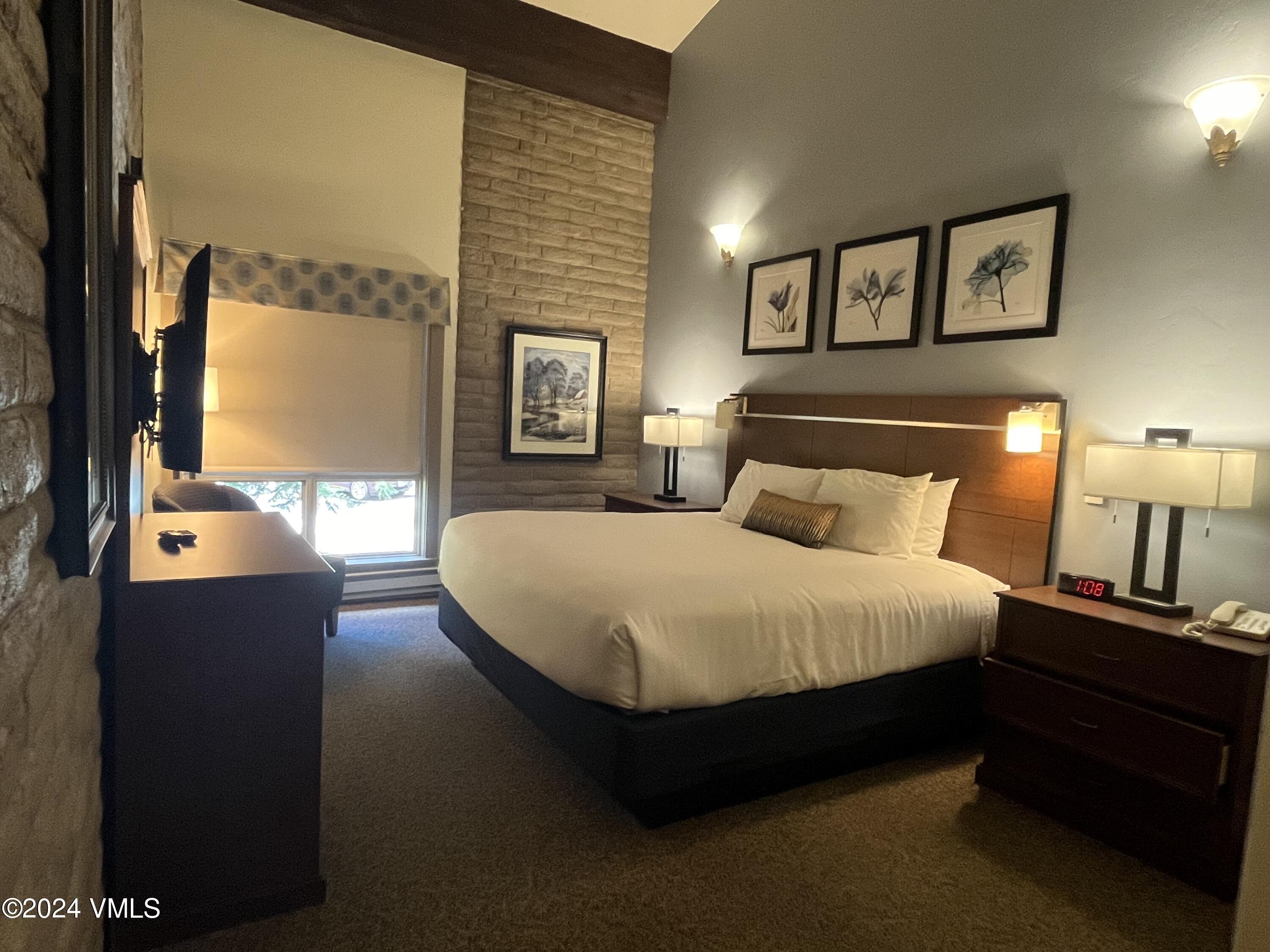 1020 Vail View Drive, Unit 230125 Vail, CO 81657 - Photo 4 of 19 a bedroom with a bed and a night stand