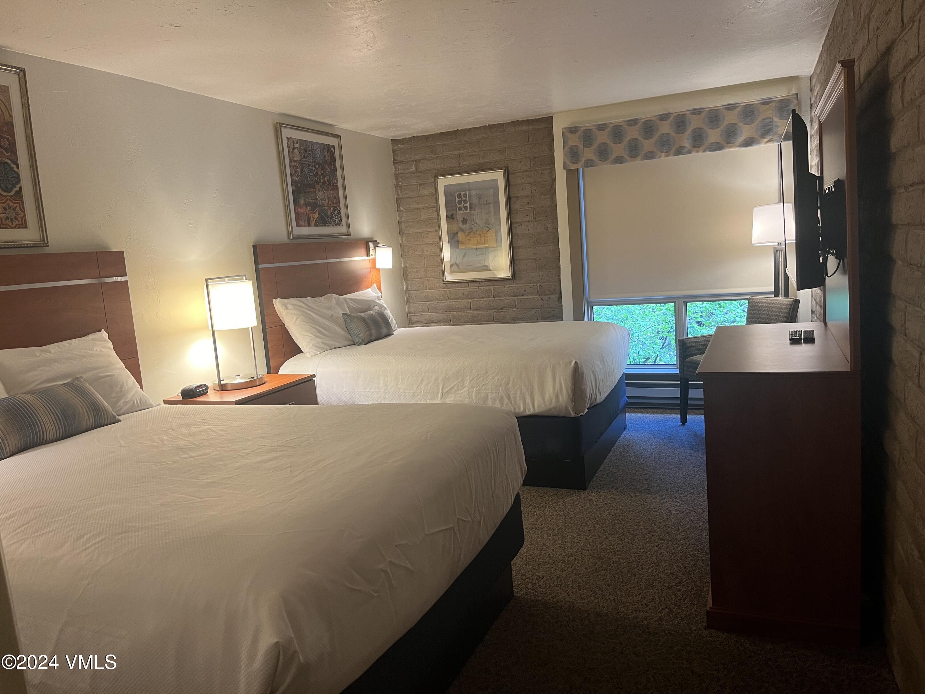 1020 Vail View Drive, Unit 230125 Vail, CO 81657 - Photo 7 of 19 a bed room with a bed window and a flat screen tv