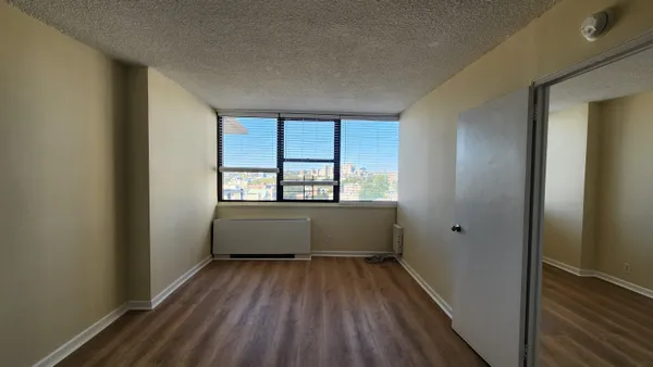 wooden floor in an empty room with a window