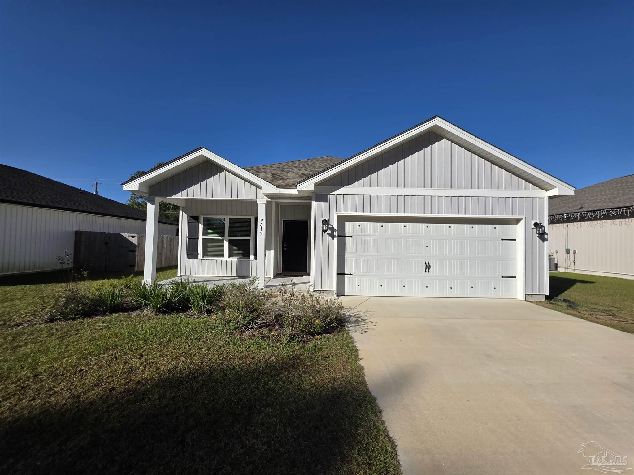 9613 Sagewood Drive Pensacola, FL 32526 - Photo 1 of 27 a front view of a house with a yard