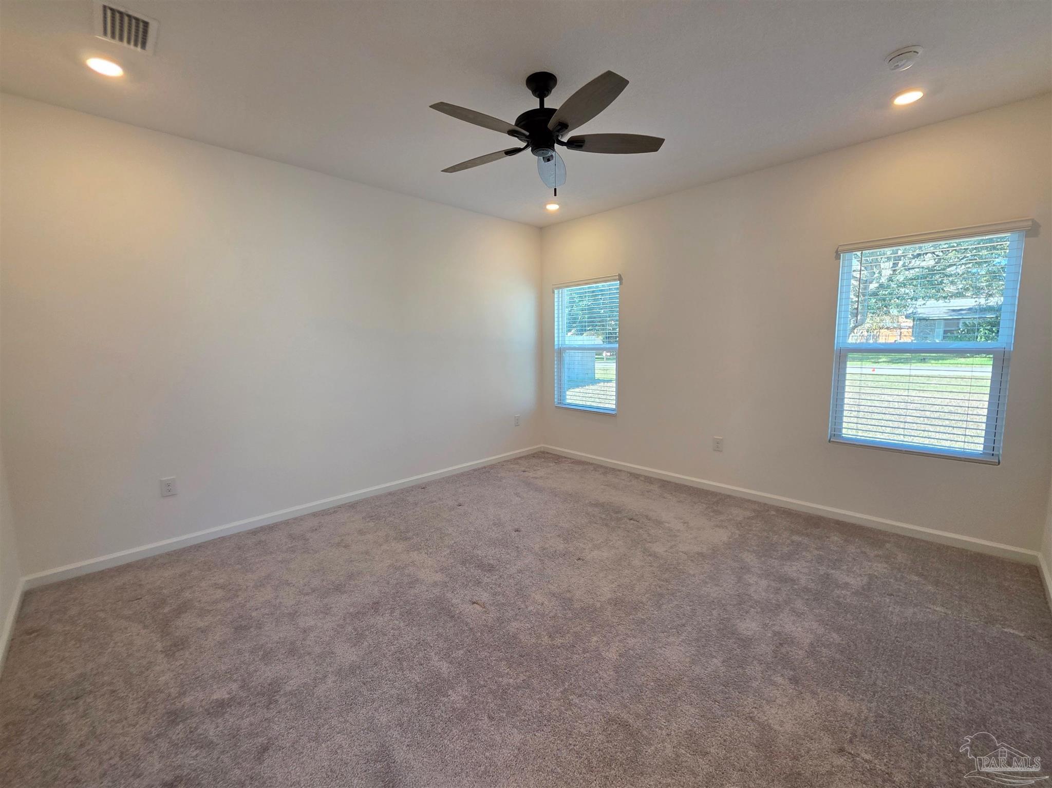 9613 Sagewood Drive Pensacola, FL 32526 - Photo 11 of 27 an empty room with windows and fan