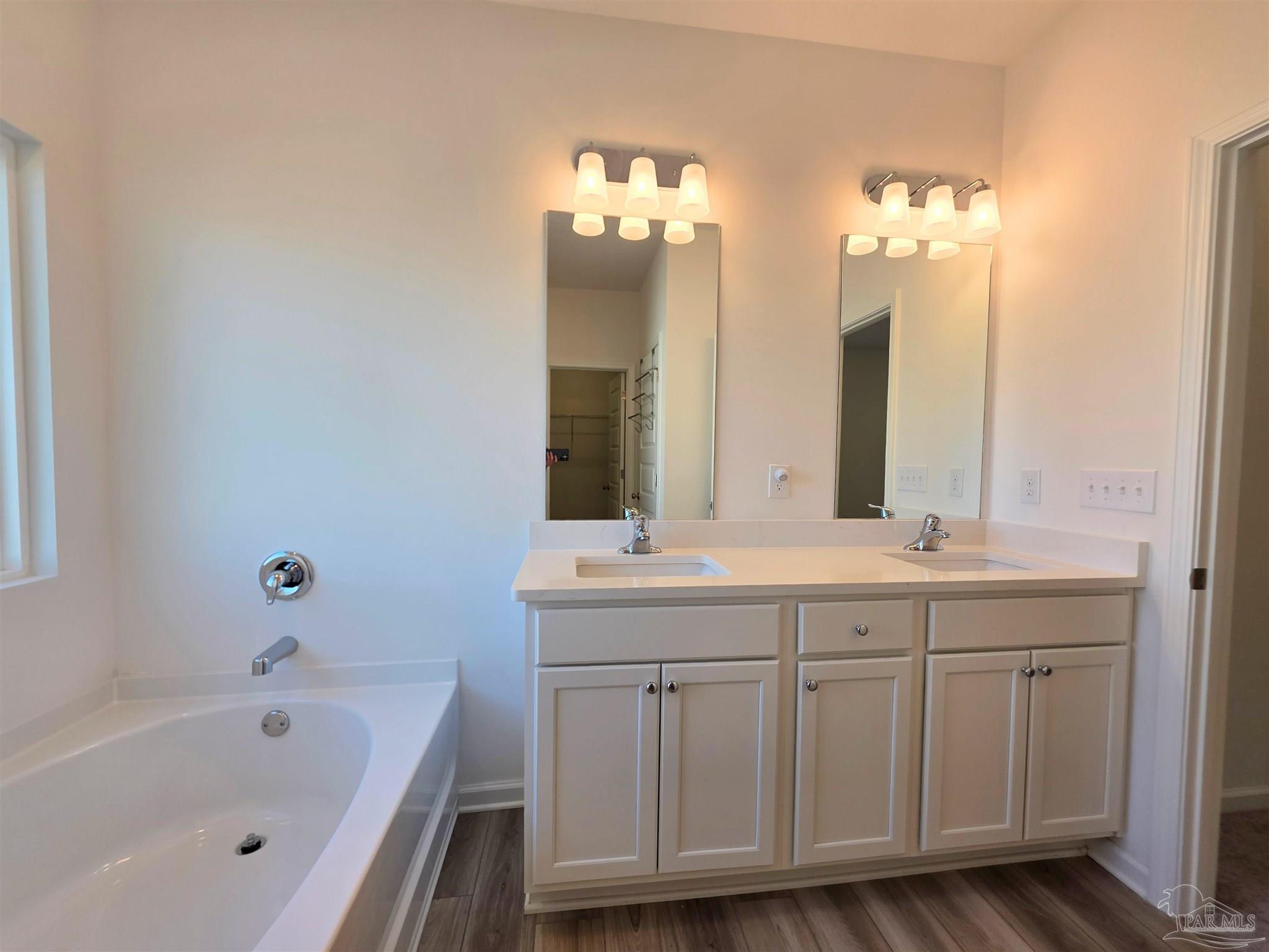 9613 Sagewood Drive Pensacola, FL 32526 - Photo 16 of 27 a bathroom with a double vanity sink and a bathtub