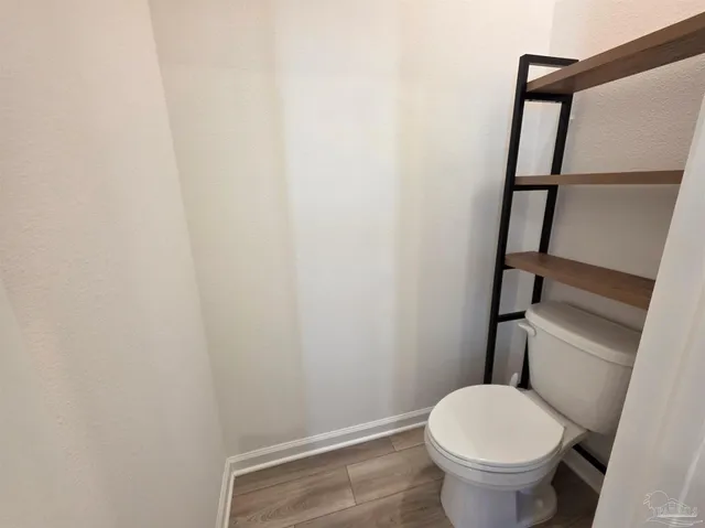 a white toilet sitting next to a shower