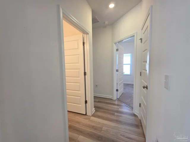 a view of a room with wooden floor and windows
