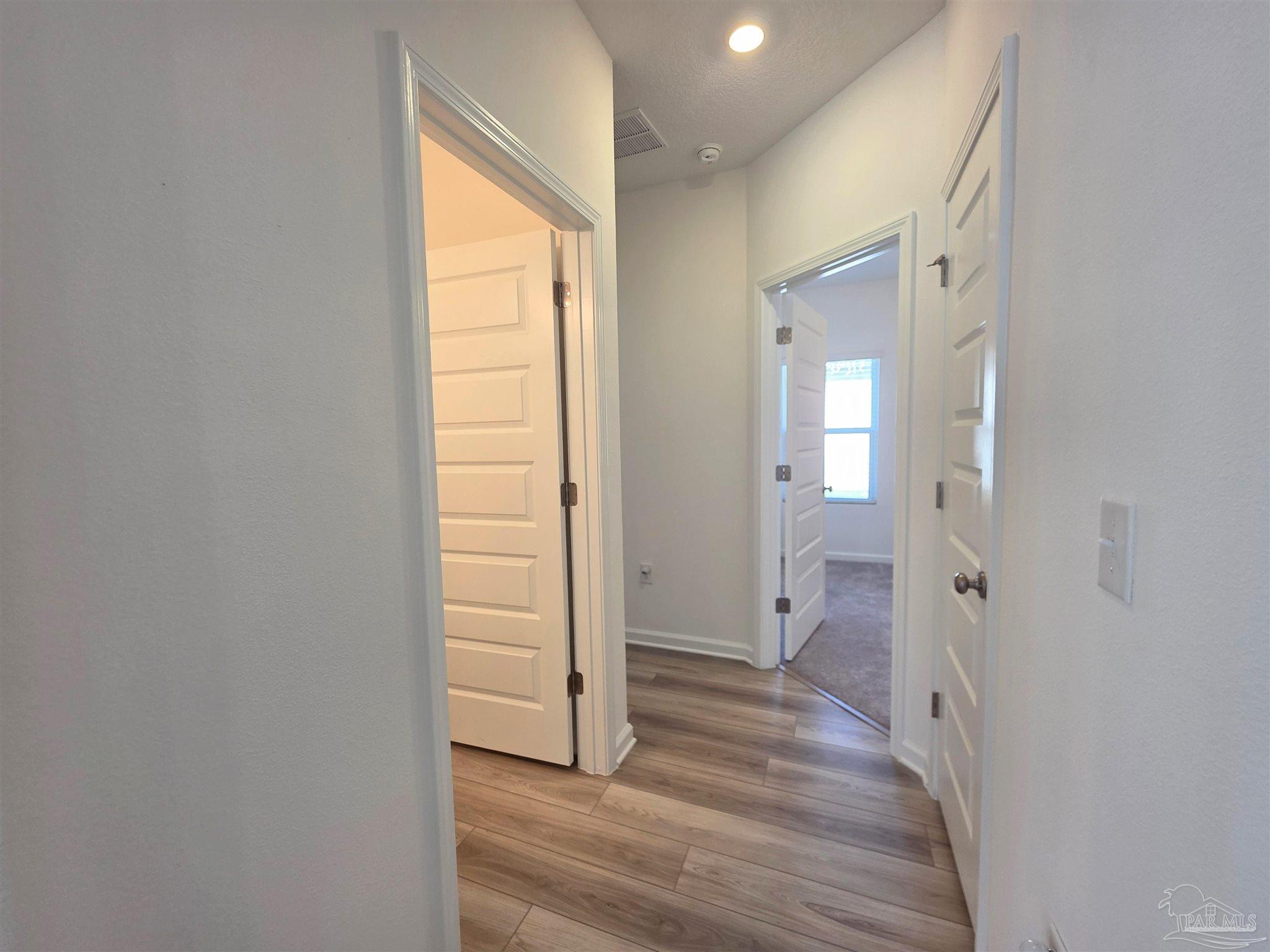 9613 Sagewood Drive Pensacola, FL 32526 - Photo 18 of 27 a view of a room with wooden floor and windows