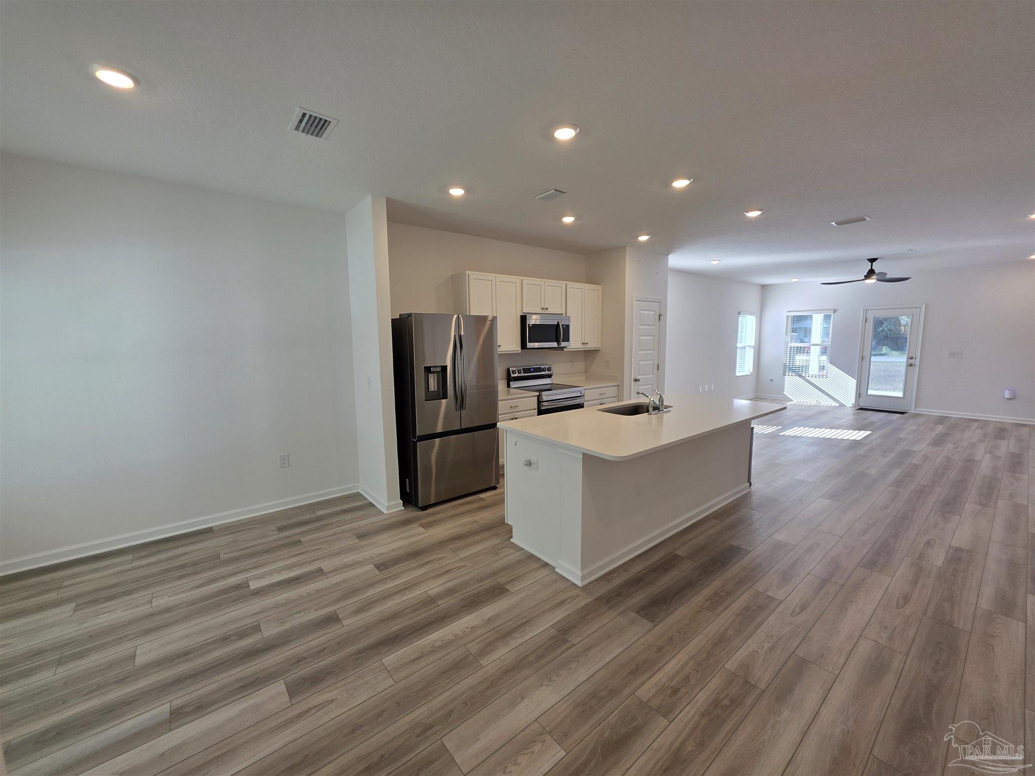 9613 Sagewood Drive Pensacola, FL 32526 - Photo 2 of 27 a large kitchen with kitchen island a sink stainless steel appliances and cabinets