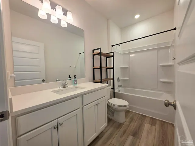 a bathroom with a sink toilet and mirror