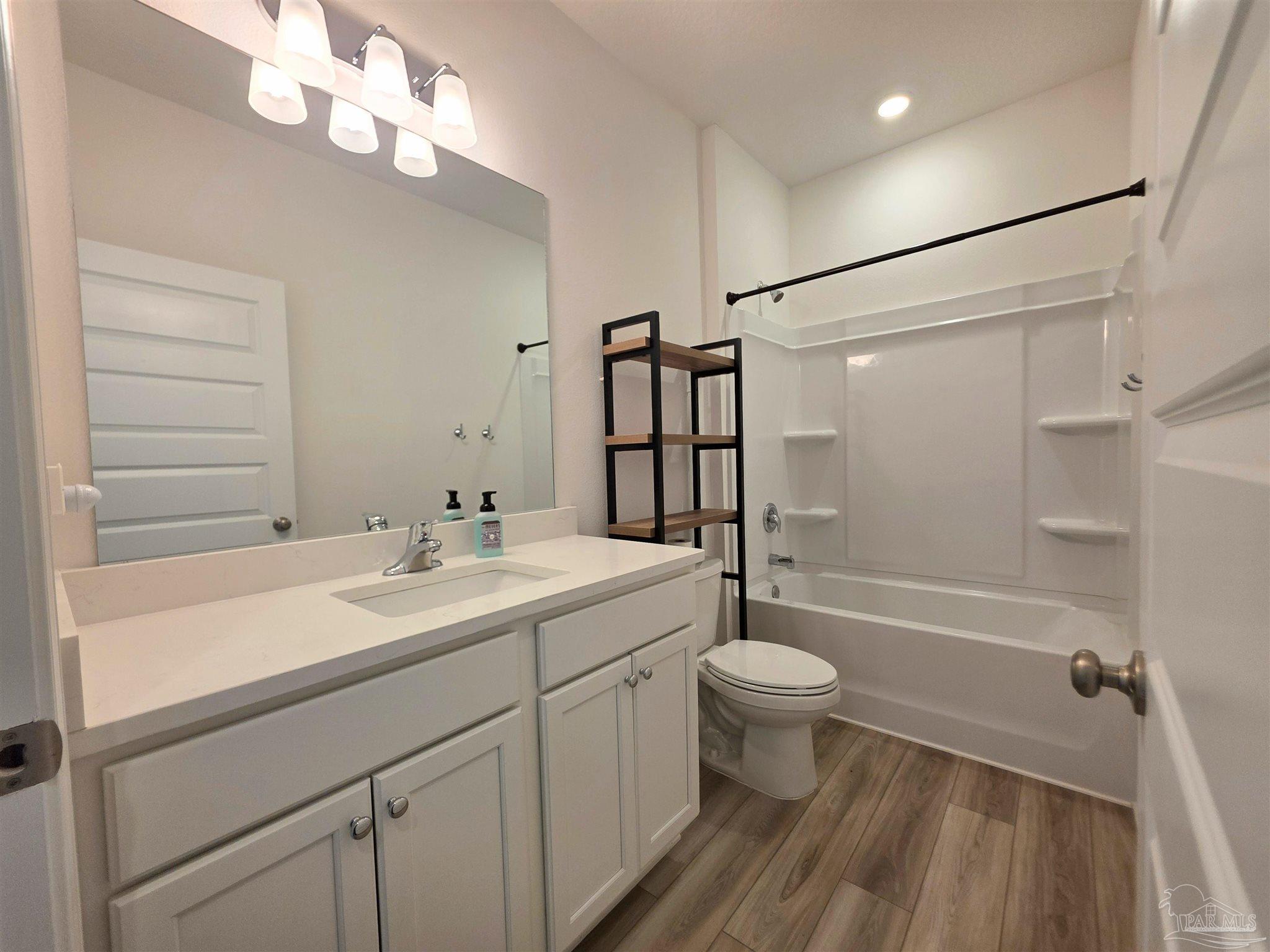9613 Sagewood Drive Pensacola, FL 32526 - Photo 22 of 27 a bathroom with a sink a toilet a mirror and shower