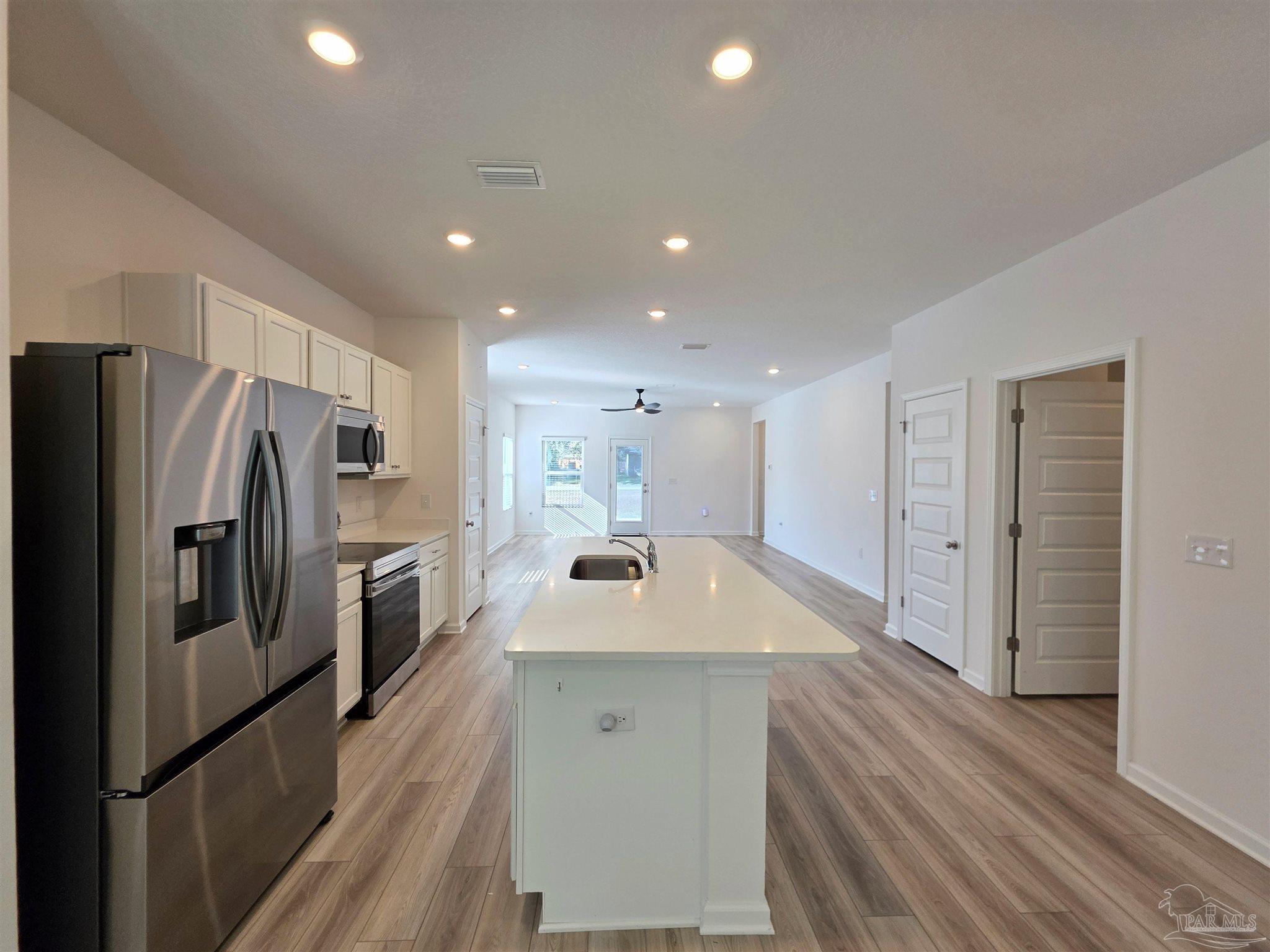 9613 Sagewood Drive Pensacola, FL 32526 - Photo 6 of 27 a kitchen with stainless steel appliances granite countertop refrigerator sink and stove