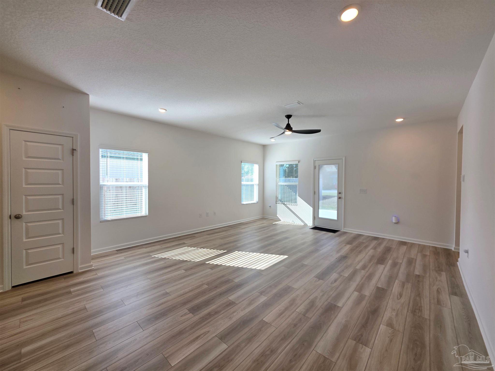 9613 Sagewood Drive Pensacola, FL 32526 - Photo 7 of 27 wooden floor in an empty room with a window