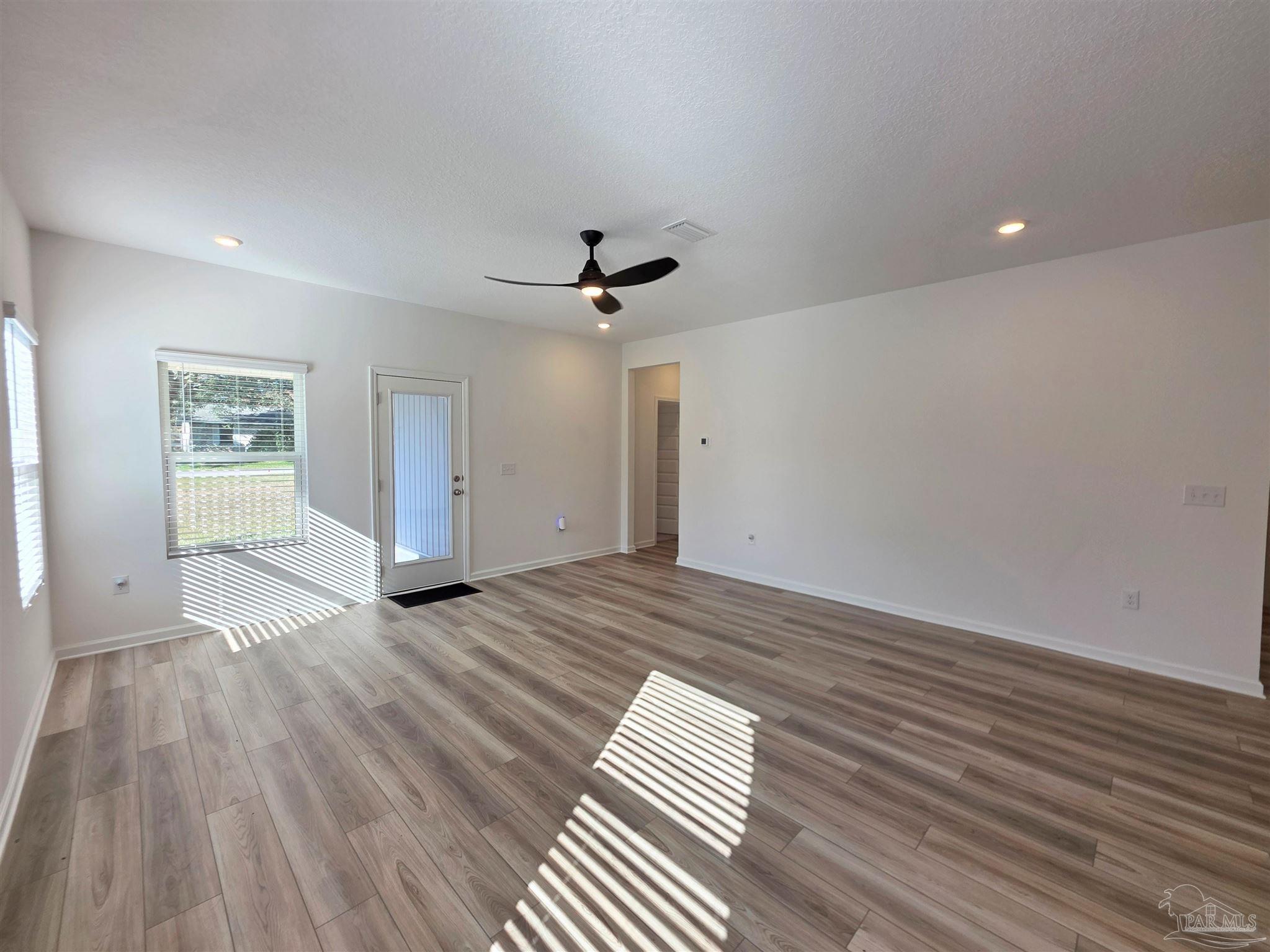 9613 Sagewood Drive Pensacola, FL 32526 - Photo 10 of 27 wooden floor in an empty room with a window