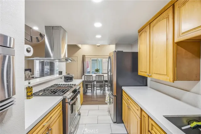 a kitchen with stainless steel appliances granite countertop a stove and a refrigerator