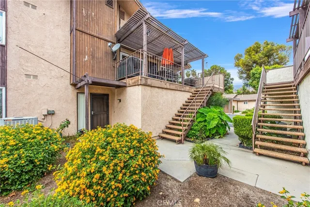 a backyard of a house with a garden and plants