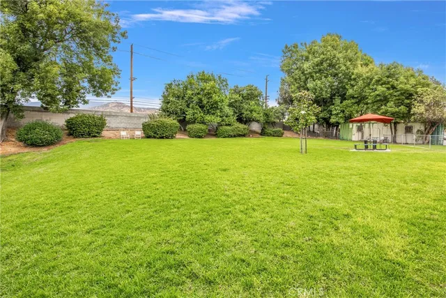 a backyard of a house with lots of green space and fountain