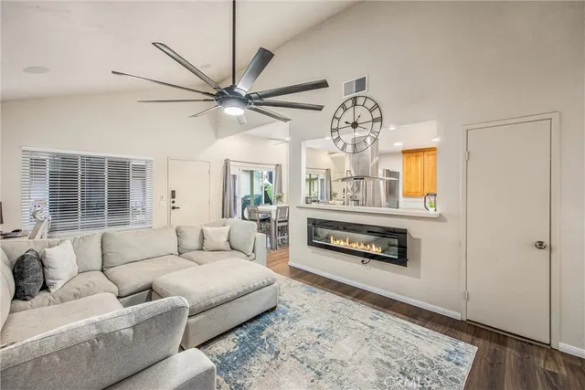 a living room with furniture a fireplace and a chandelier