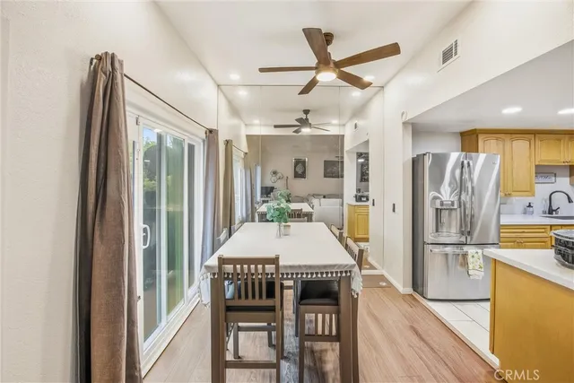 a kitchen with stainless steel appliances a refrigerator and a table