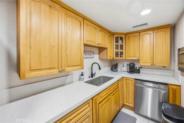 a kitchen with a sink a counter top space and cabinets
