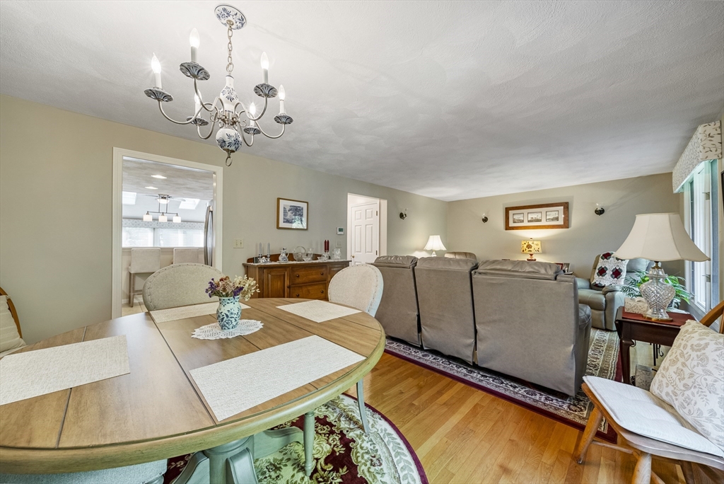 21 Tulip Circle, Unit 21 Haverhill, MA 01830 - Photo 11 of 26 a living room with furniture a chandelier and a dining table