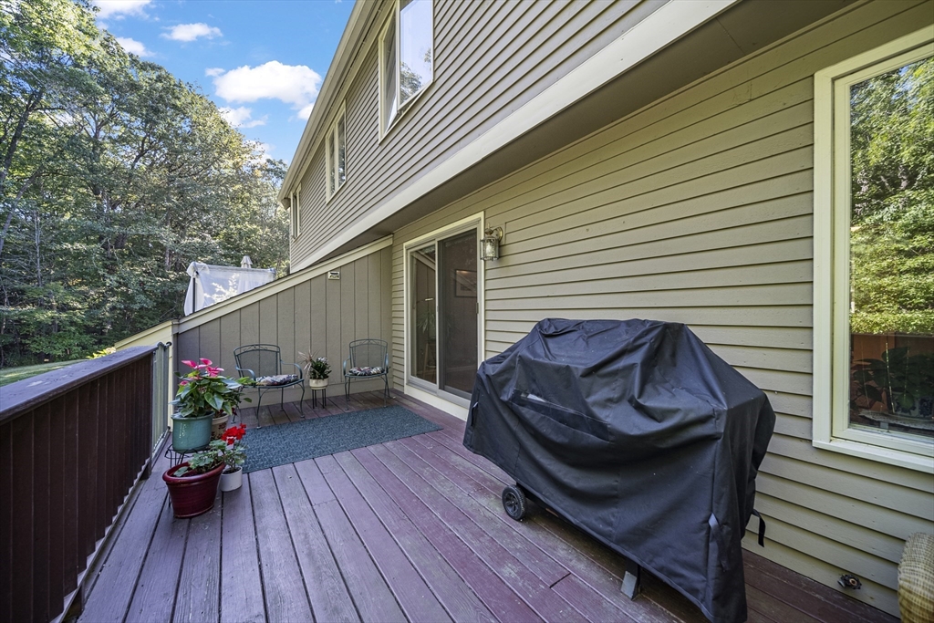 21 Tulip Circle, Unit 21 Haverhill, MA 01830 - Photo 13 of 26 a view of sitting area in balcony with wooden floor and seating space