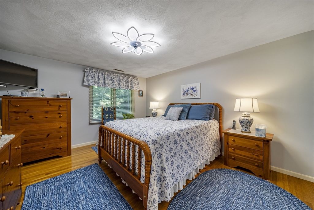 21 Tulip Circle, Unit 21 Haverhill, MA 01830 - Photo 14 of 26 a bedroom with a bed and a chandelier