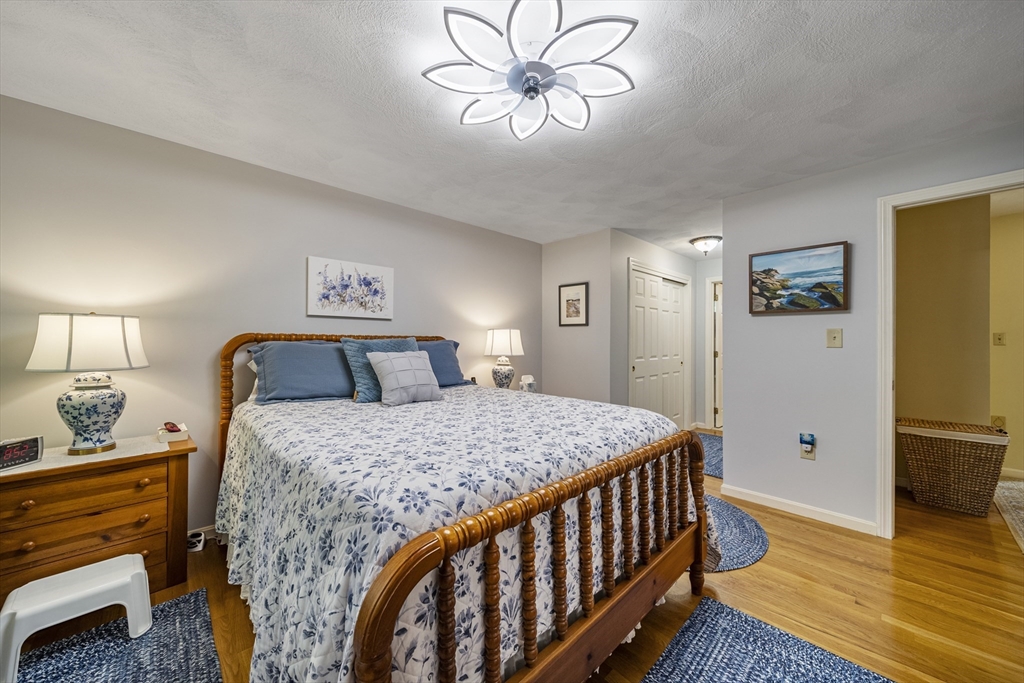 21 Tulip Circle, Unit 21 Haverhill, MA 01830 - Photo 15 of 26 a bedroom with a bed and wooden floor