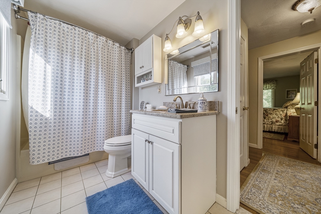 21 Tulip Circle, Unit 21 Haverhill, MA 01830 - Photo 18 of 26 a bathroom with a sink a toilet and shower