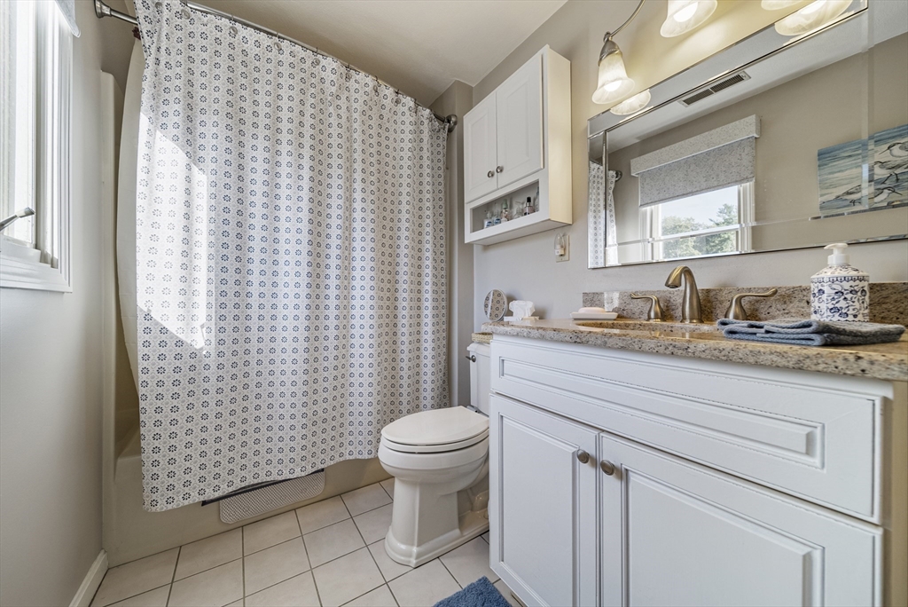 21 Tulip Circle, Unit 21 Haverhill, MA 01830 - Photo 19 of 26 a bathroom with a granite countertop sink toilet and shower