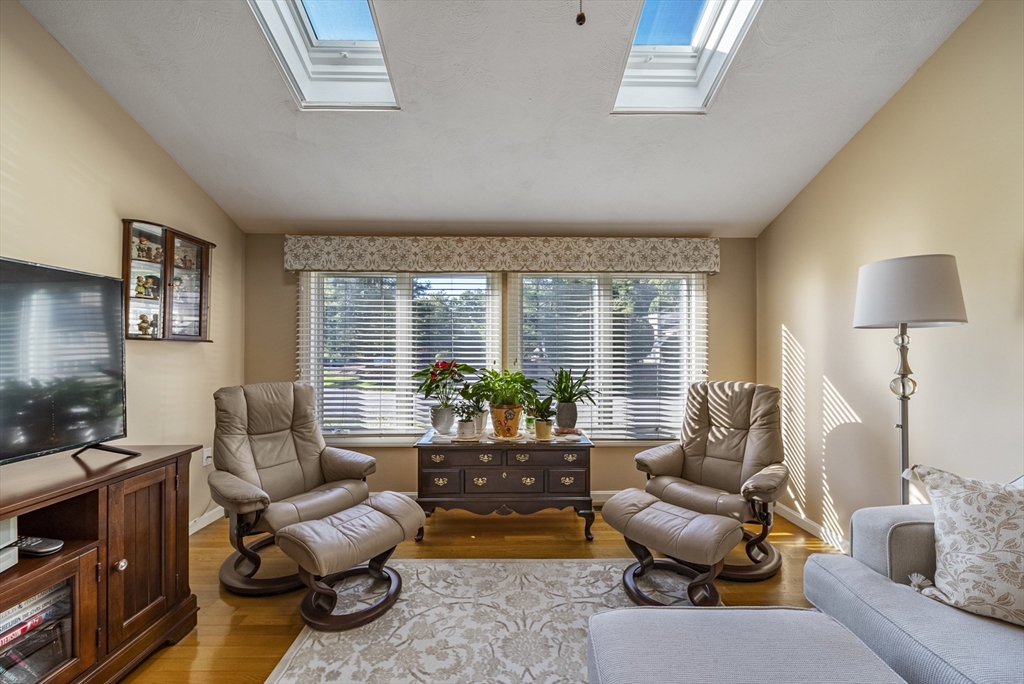 21 Tulip Circle, Unit 21 Haverhill, MA 01830 - Photo 2 of 26 a living room with furniture and a lamp