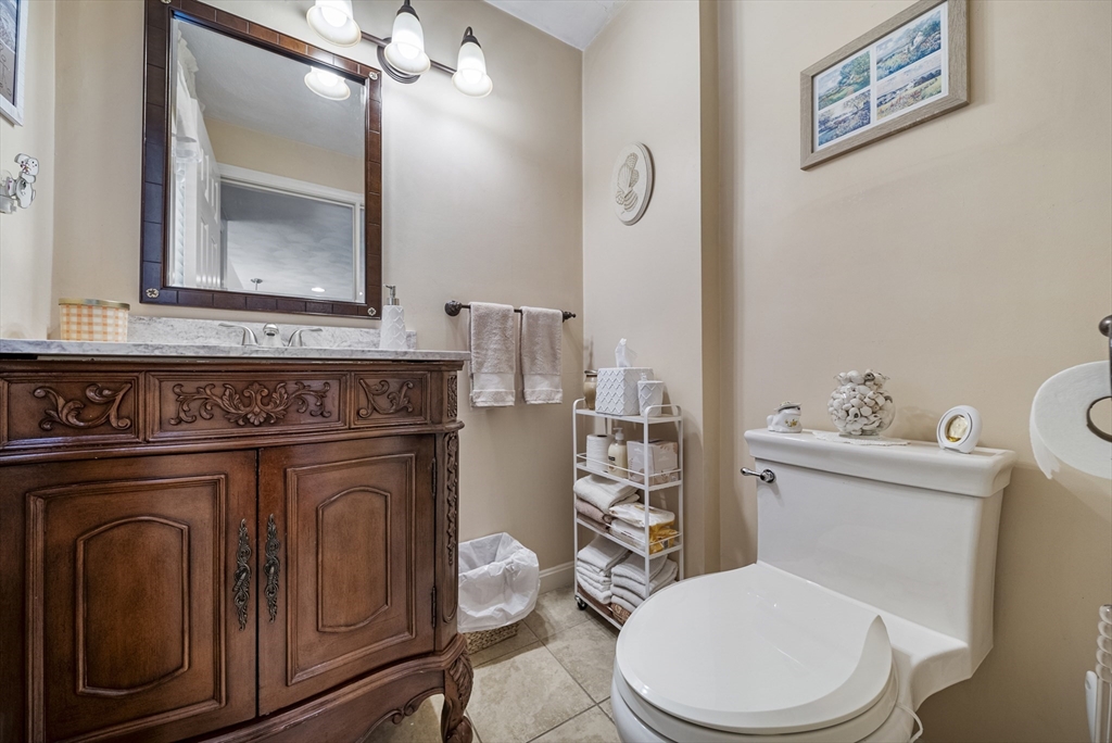 21 Tulip Circle, Unit 21 Haverhill, MA 01830 - Photo 6 of 26 a bathroom with a toilet a sink and mirror