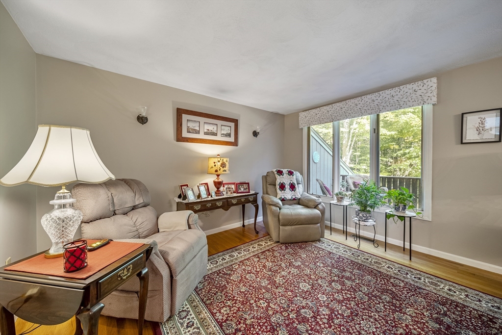 21 Tulip Circle, Unit 21 Haverhill, MA 01830 - Photo 8 of 26 a living room with furniture and a window