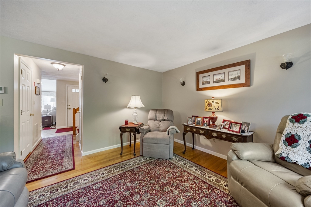 21 Tulip Circle, Unit 21 Haverhill, MA 01830 - Photo 9 of 26 a living room with furniture and a rug