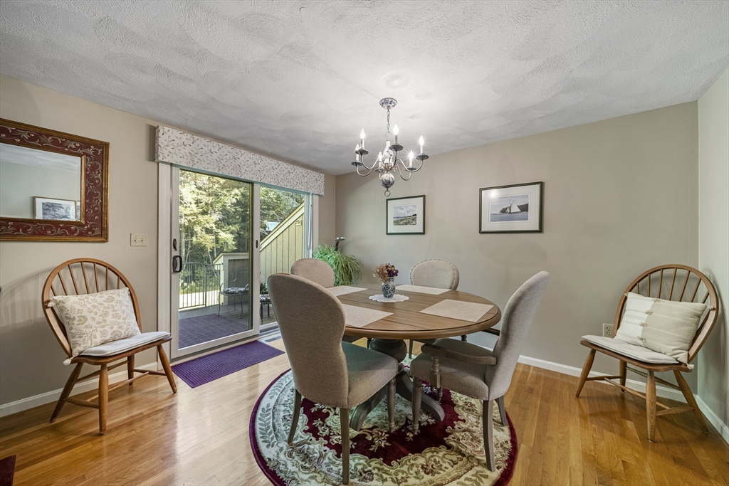 21 Tulip Circle, Unit 21 Haverhill, MA 01830 - Photo 10 of 26 a view of a dining room with furniture window and wooden floor