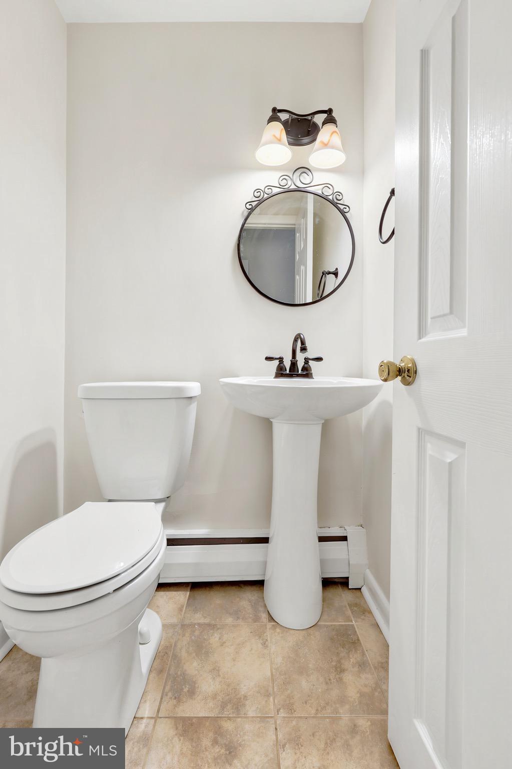 412 Yorkshire Road Bryn Mawr, PA 19010 - Photo 4 of 25 a white toilet sitting next to a bathroom sink