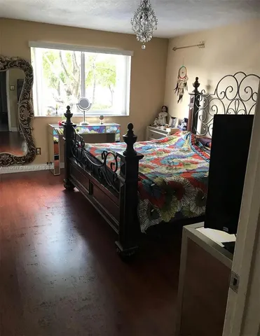 a bedroom with a bed and a tv on table